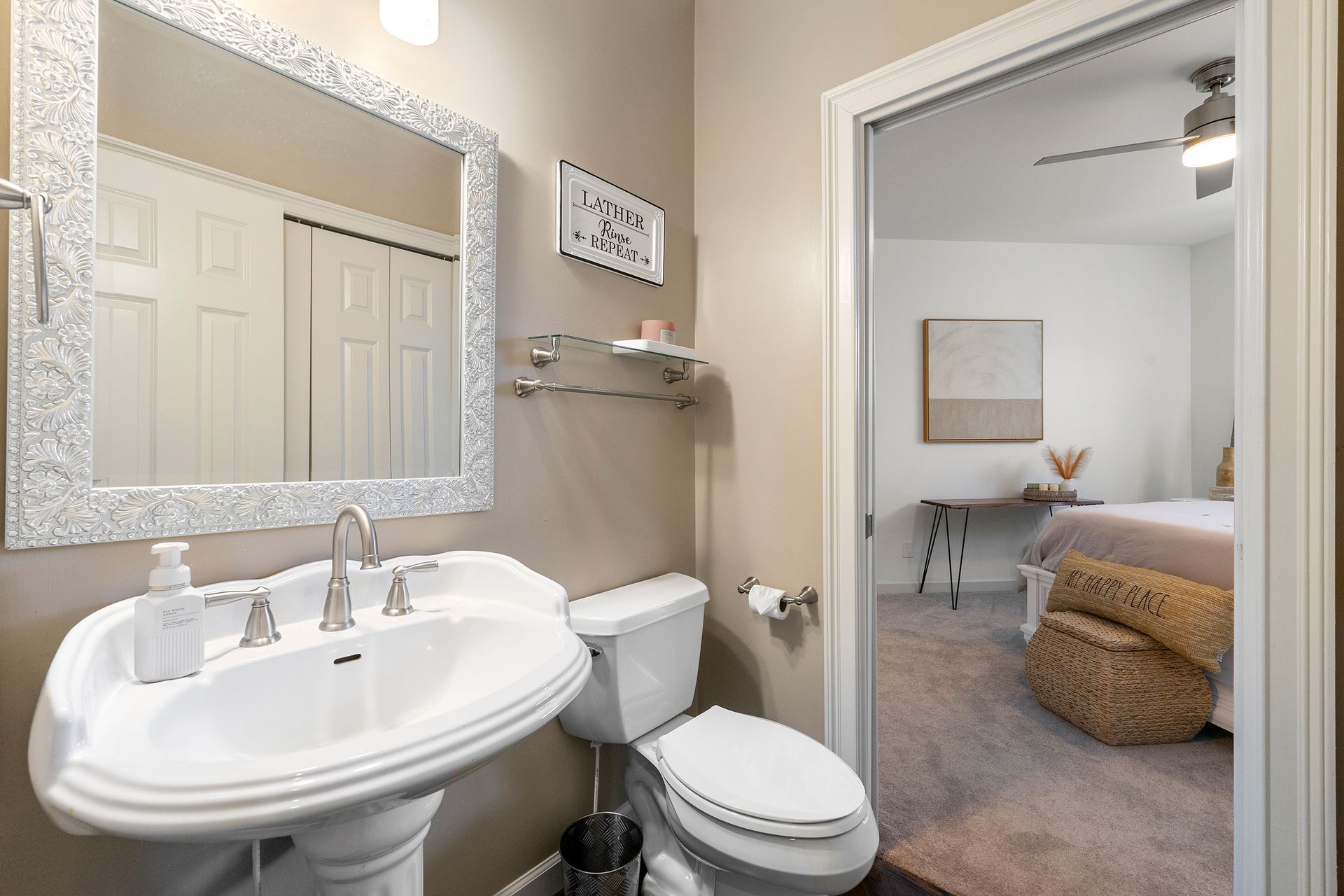 A bathroom with a sink , toilet and mirror.