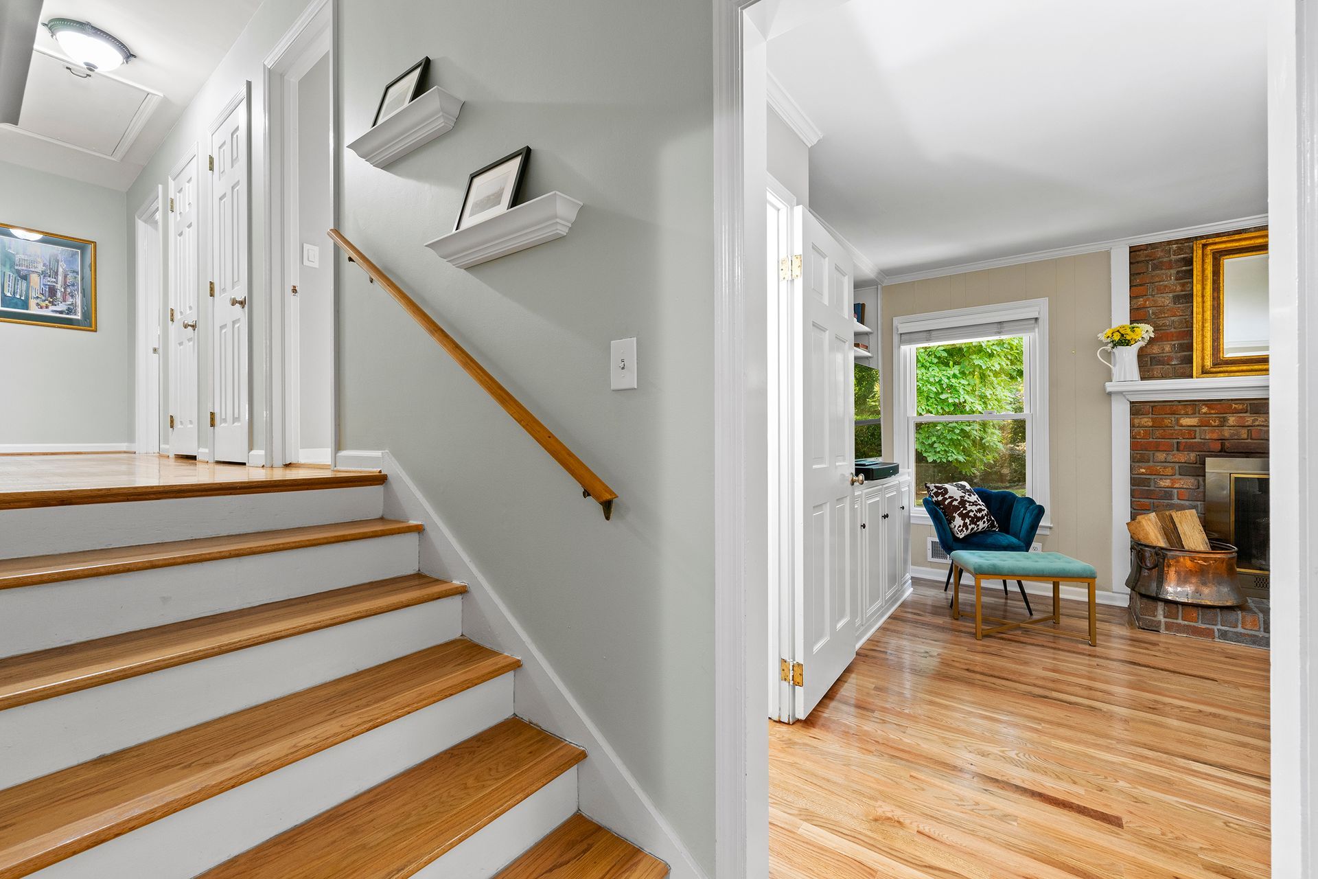 A staircase leading up to a living room in a house.