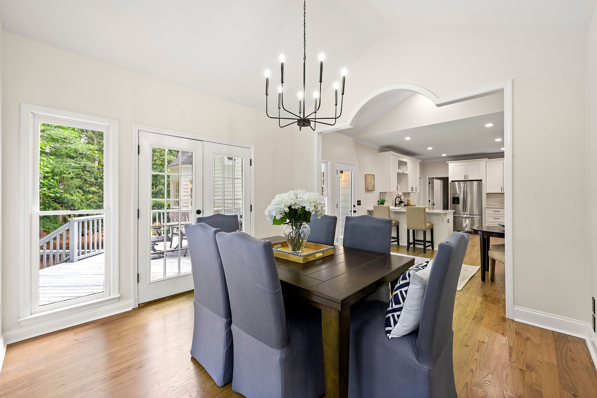 A dining room with a table and chairs and a chandelier.