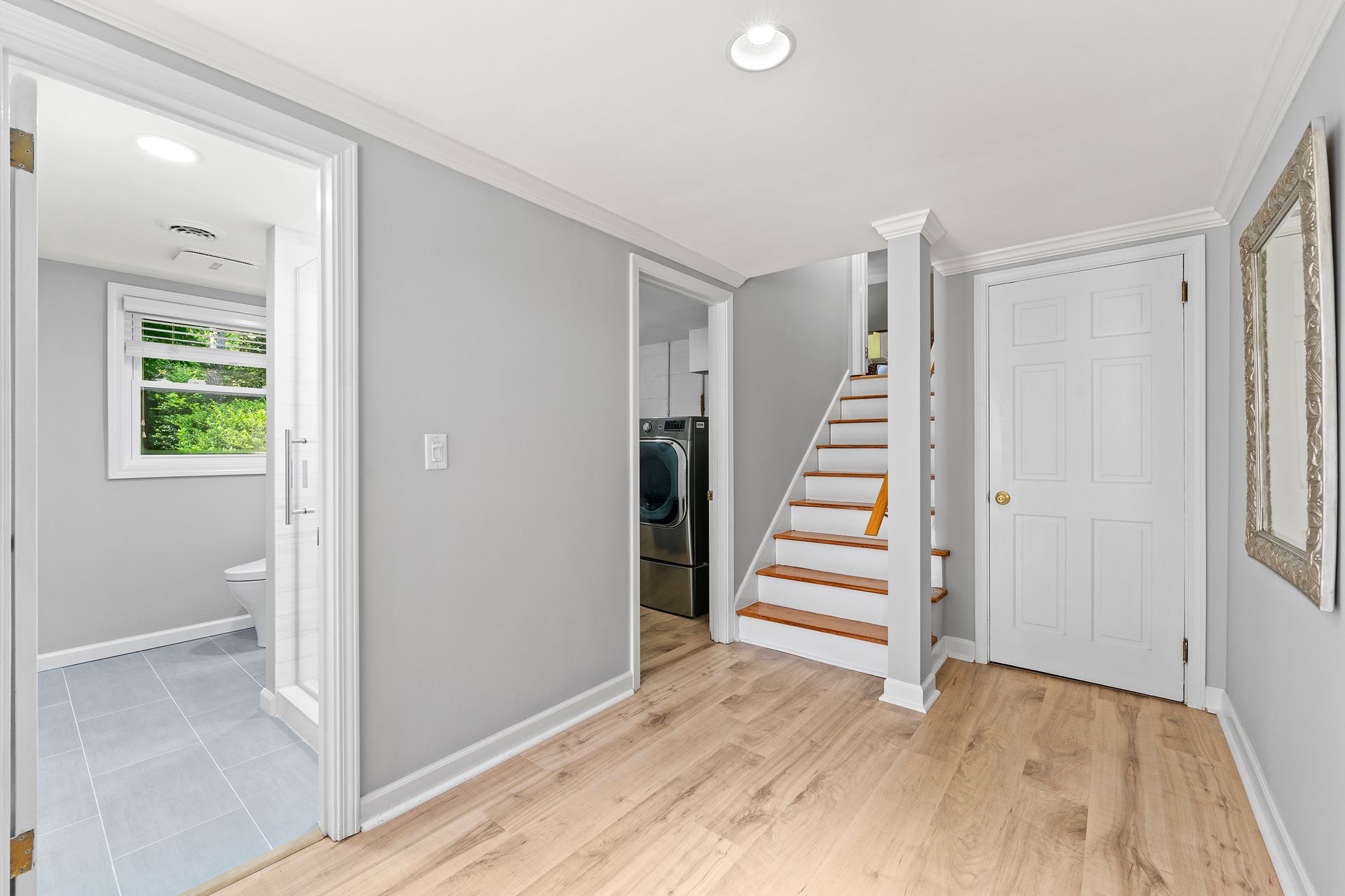 A hallway with stairs leading up to the second floor of a house.