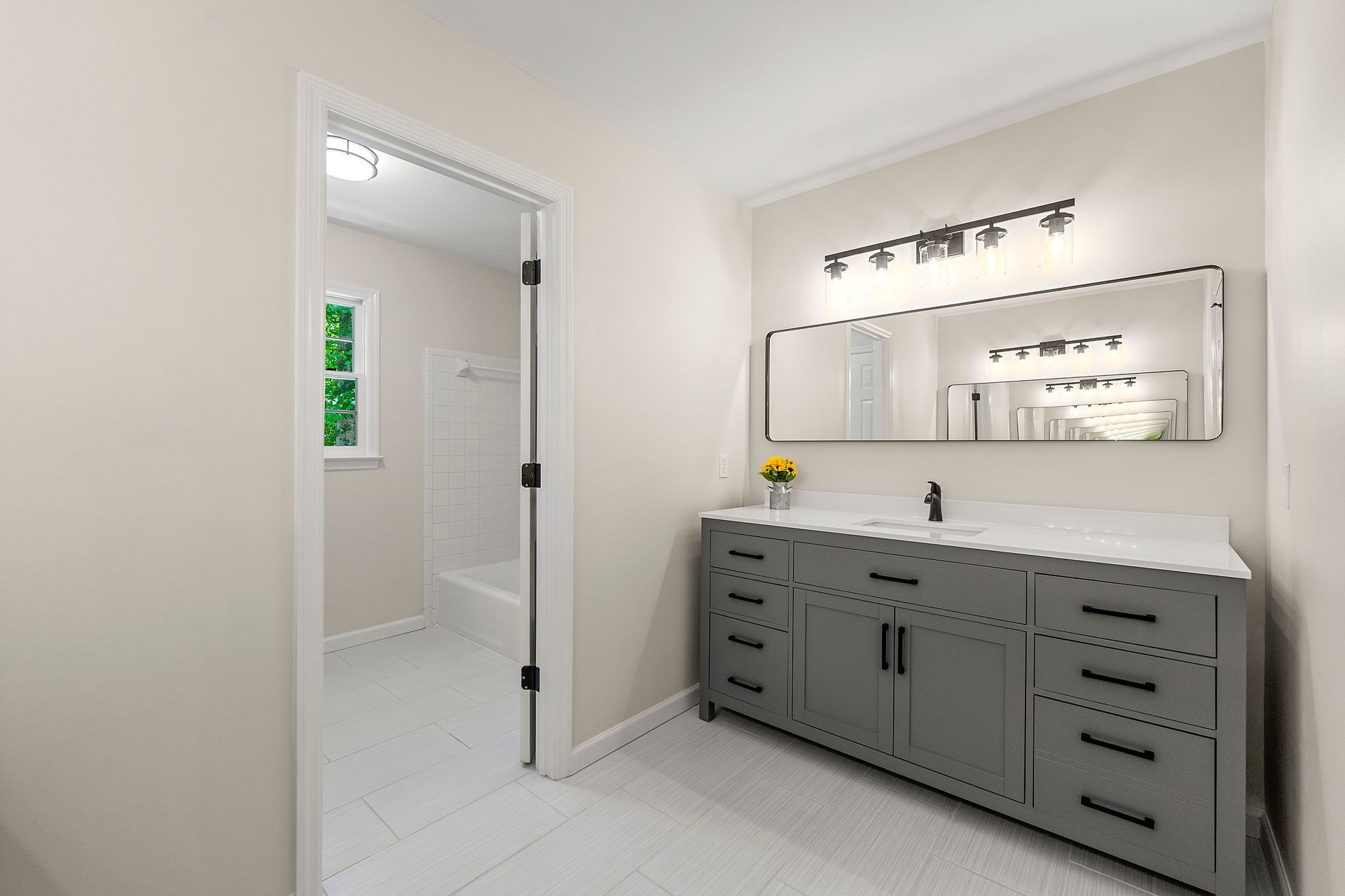 A bathroom with two sinks and a large mirror.