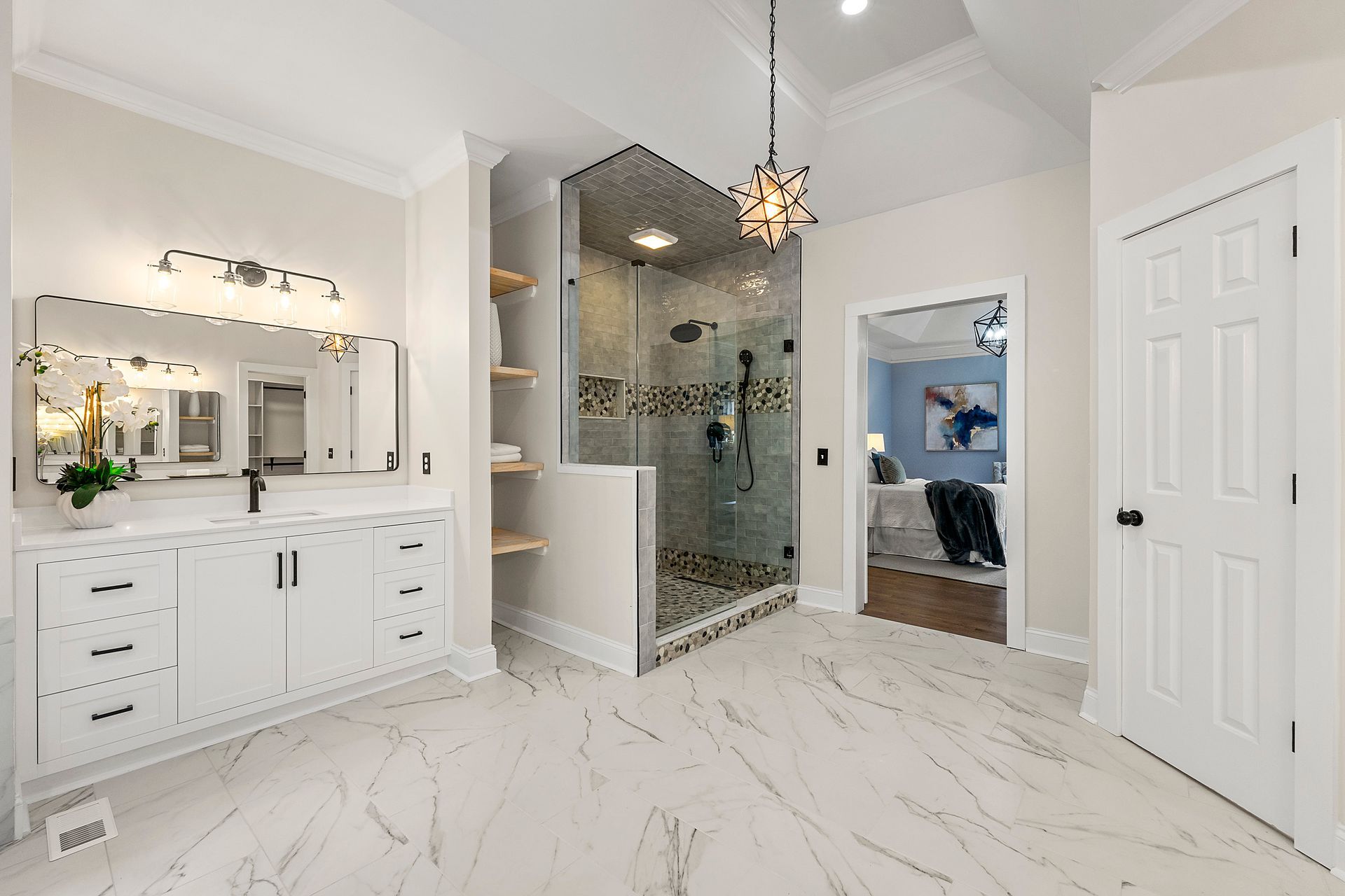 A bathroom with a walk in shower , sink and mirror.