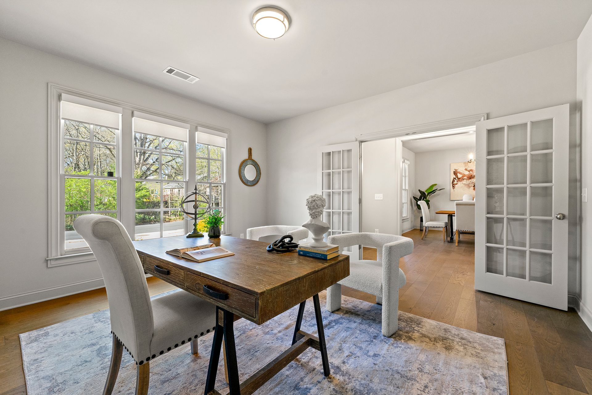 There is a desk and chairs in the dining room.
