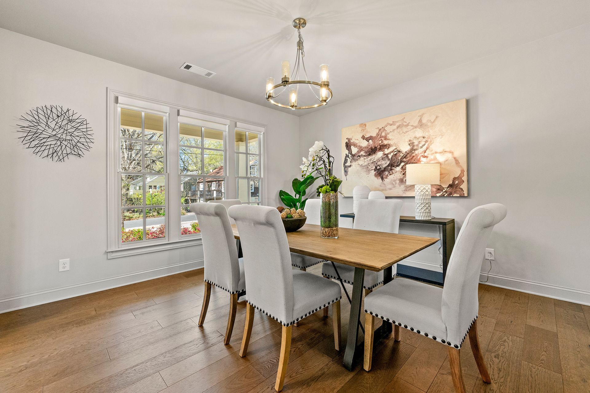 A dining room with a table and chairs and a chandelier.