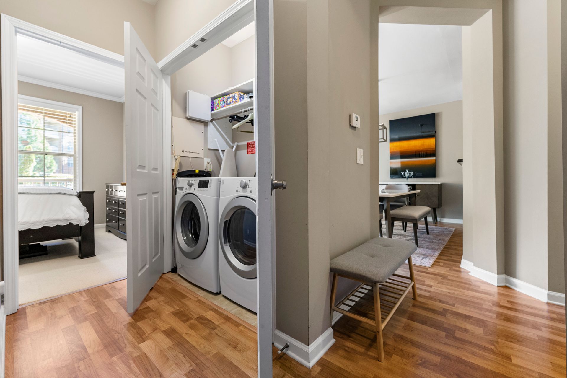A laundry room with a washer and dryer in a house.
