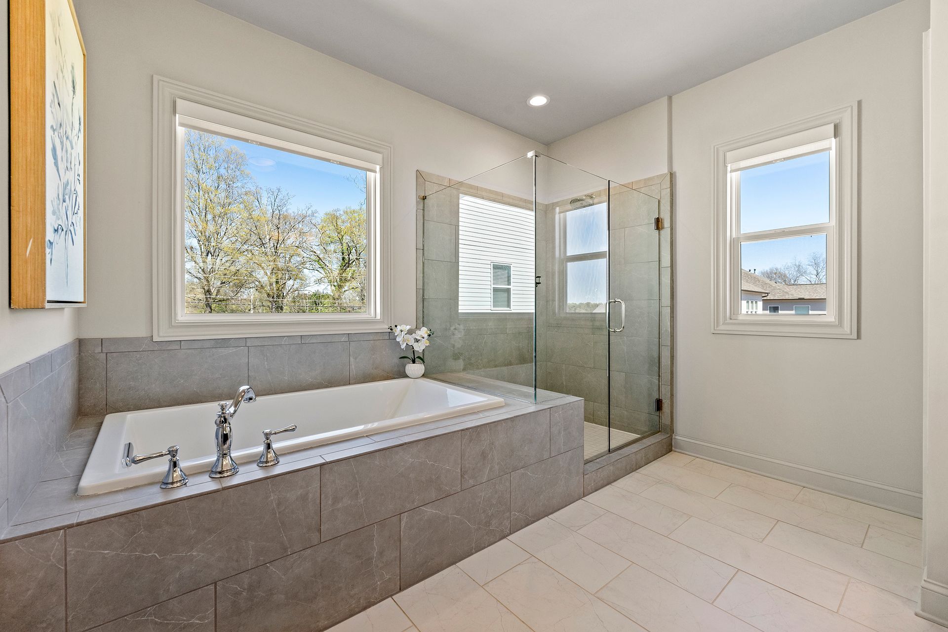 A bathroom with a large tub and a walk in shower.