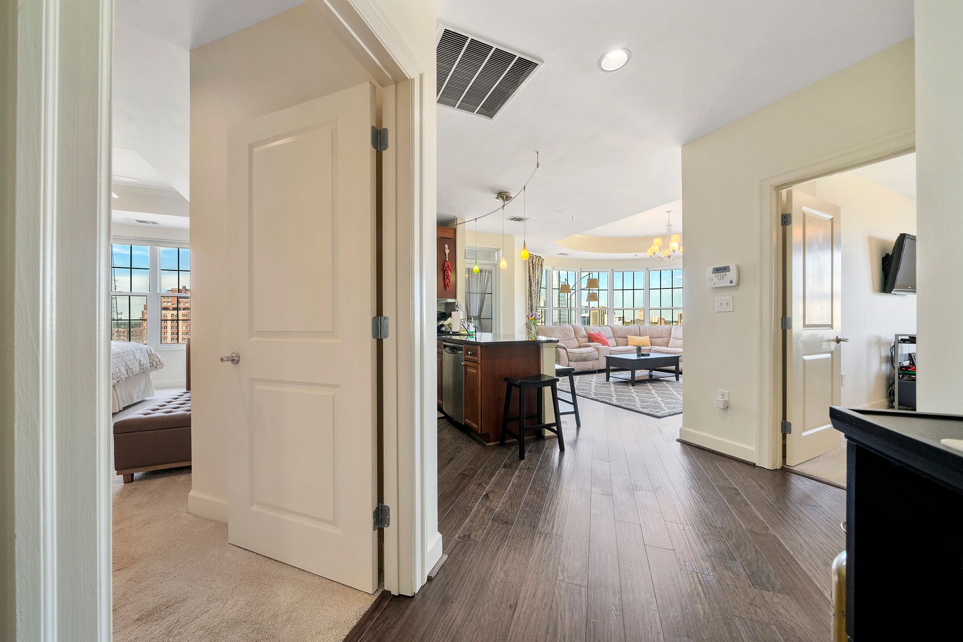 A hallway leading to a living room in a house.