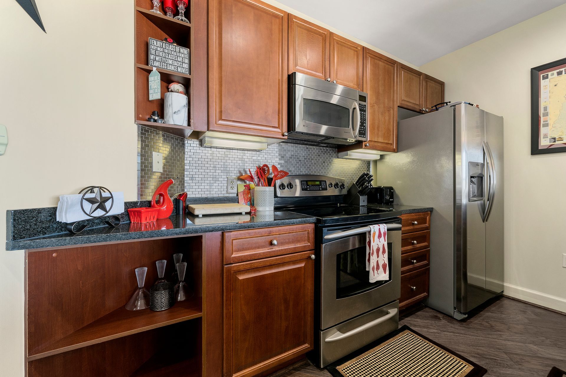 A kitchen with stainless steel appliances and wooden cabinets