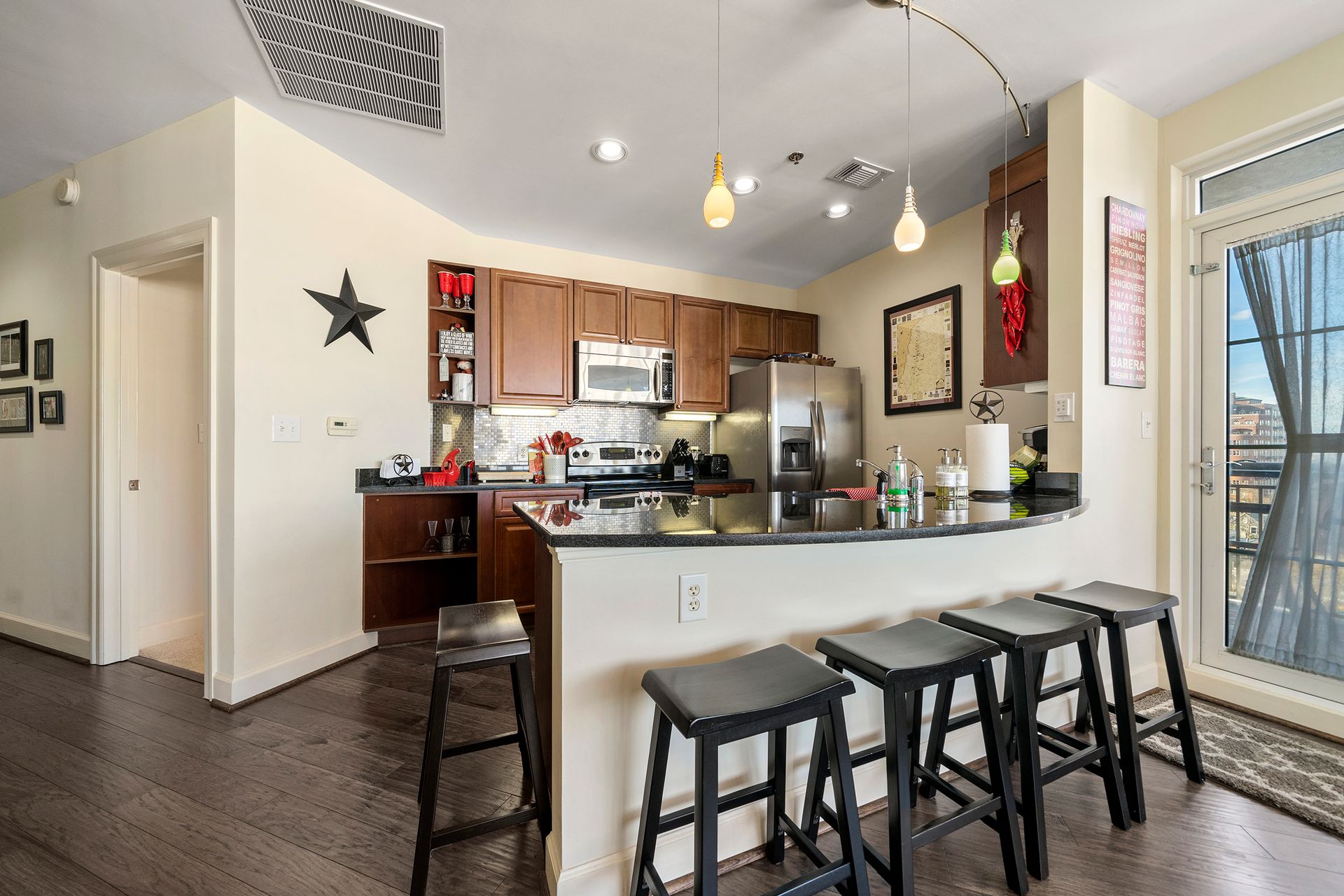 A kitchen with a bar and stools in it