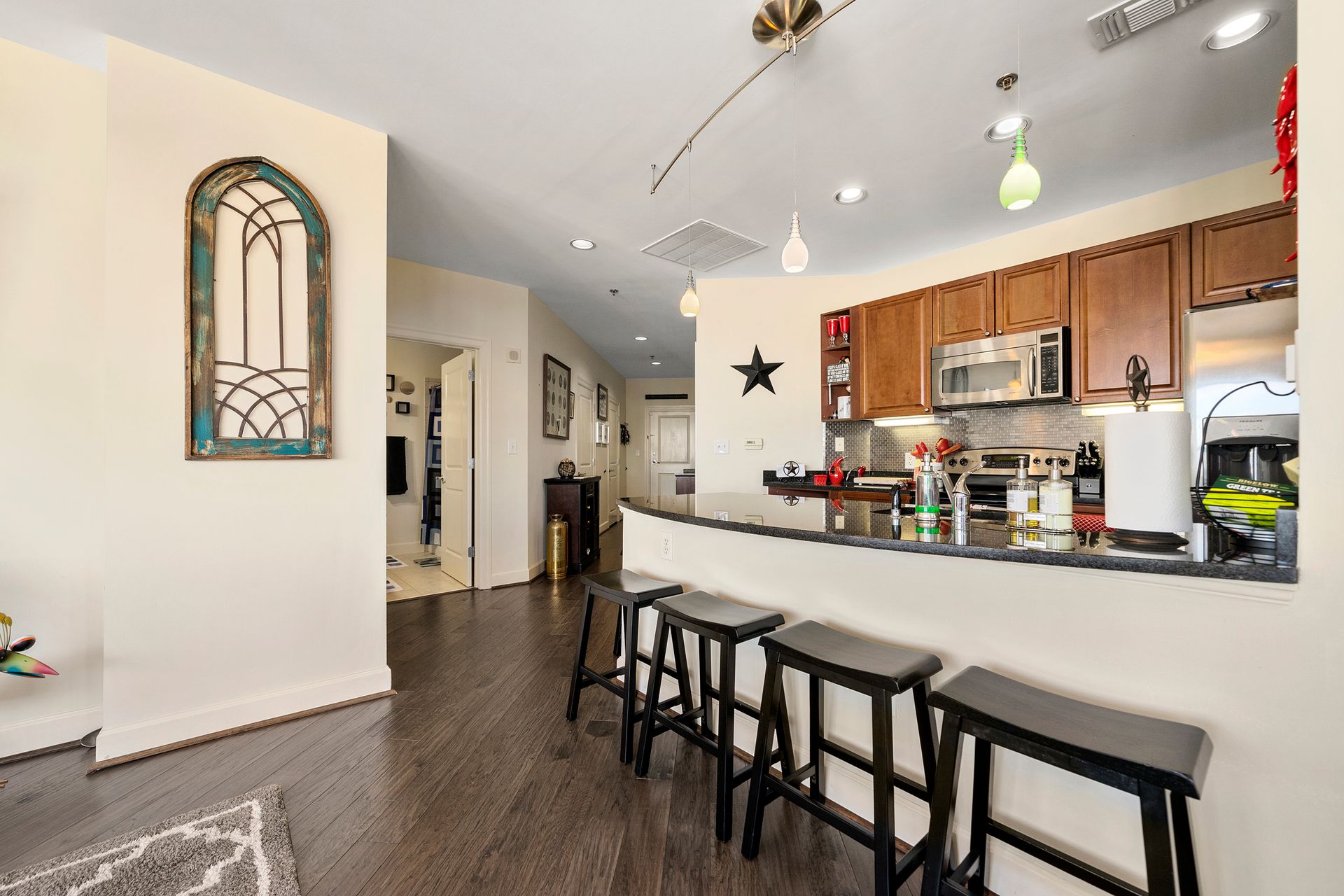 A kitchen with a bar and stools in it