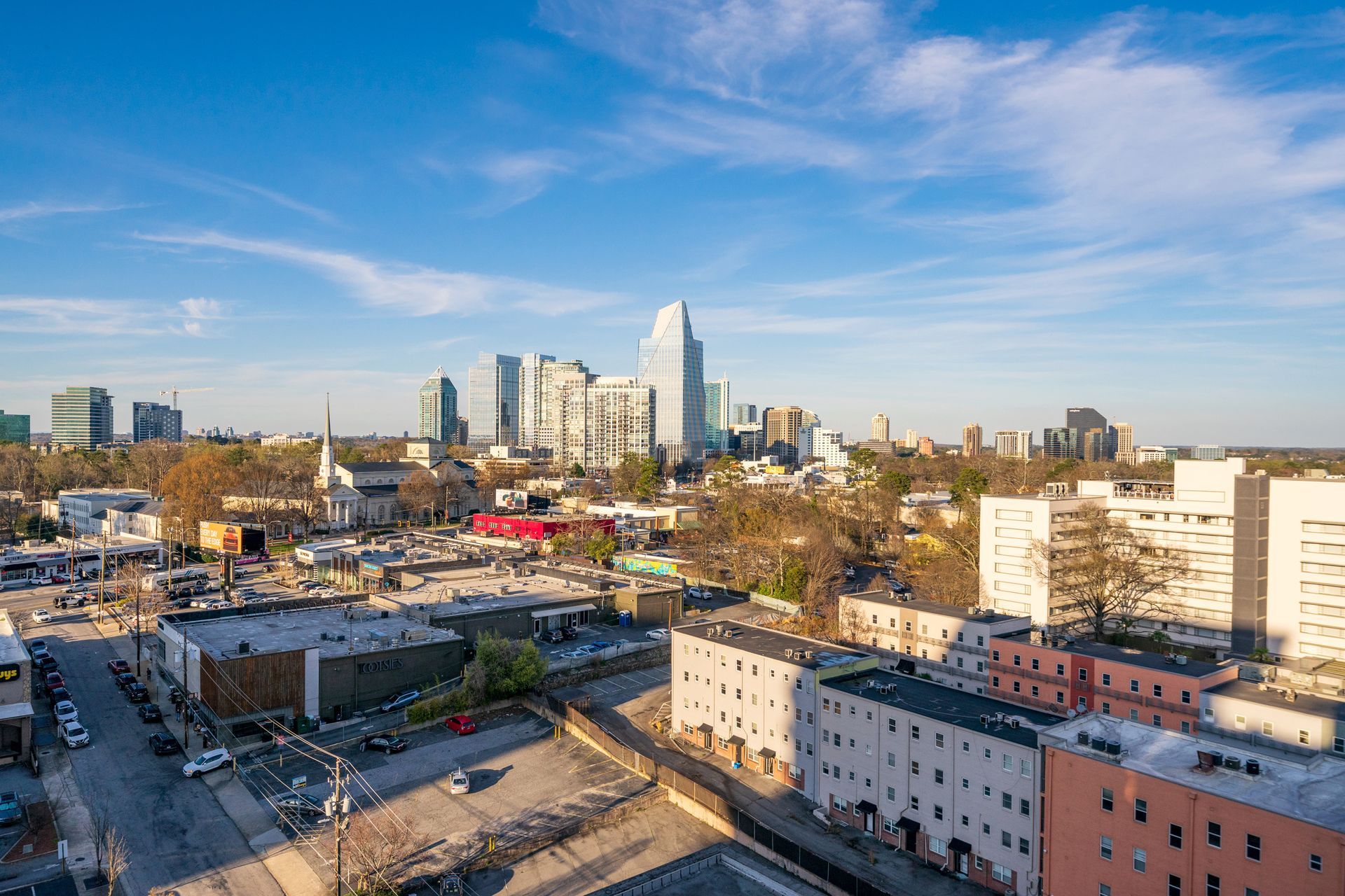 An aerial view of a city with a lot of buildings and a blue sky.