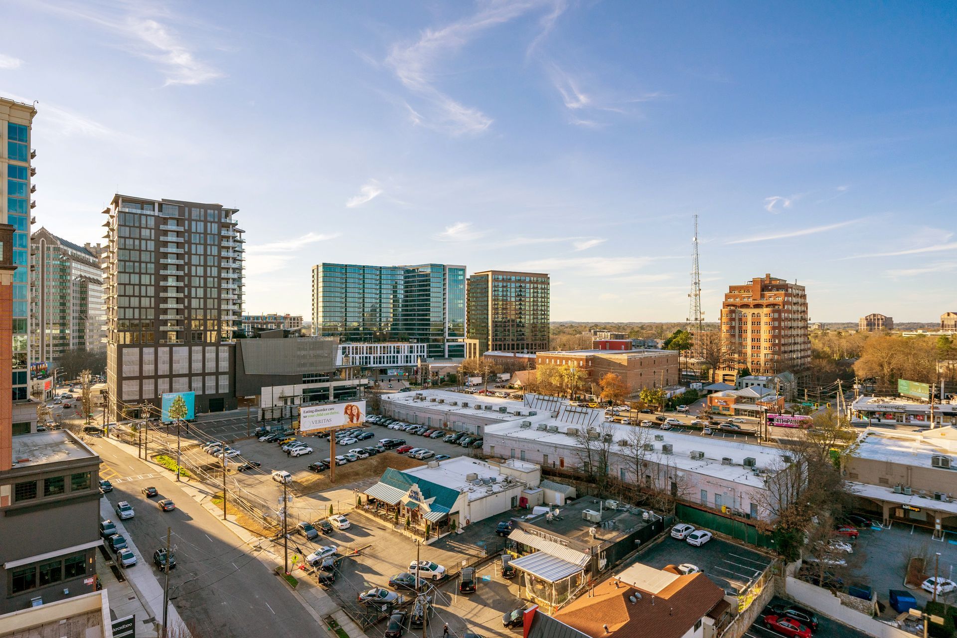 An aerial view of a city with a lot of buildings and cars.