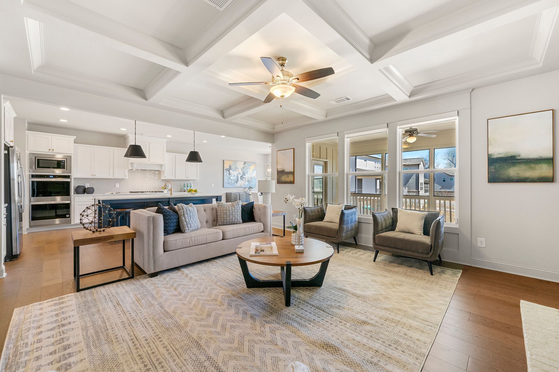 A living room filled with furniture and a ceiling fan.