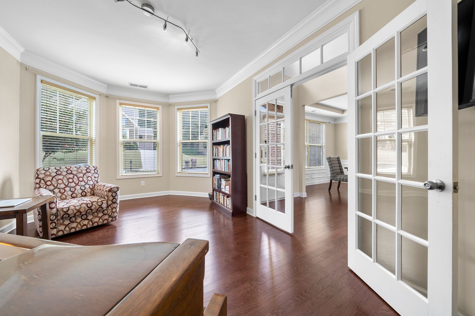 A living room with hardwood floors and french doors