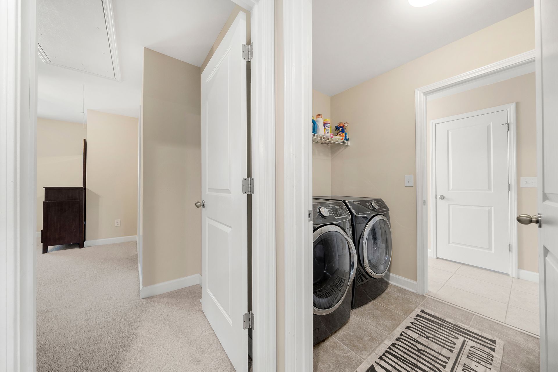 A laundry room with a washer and dryer in a house.