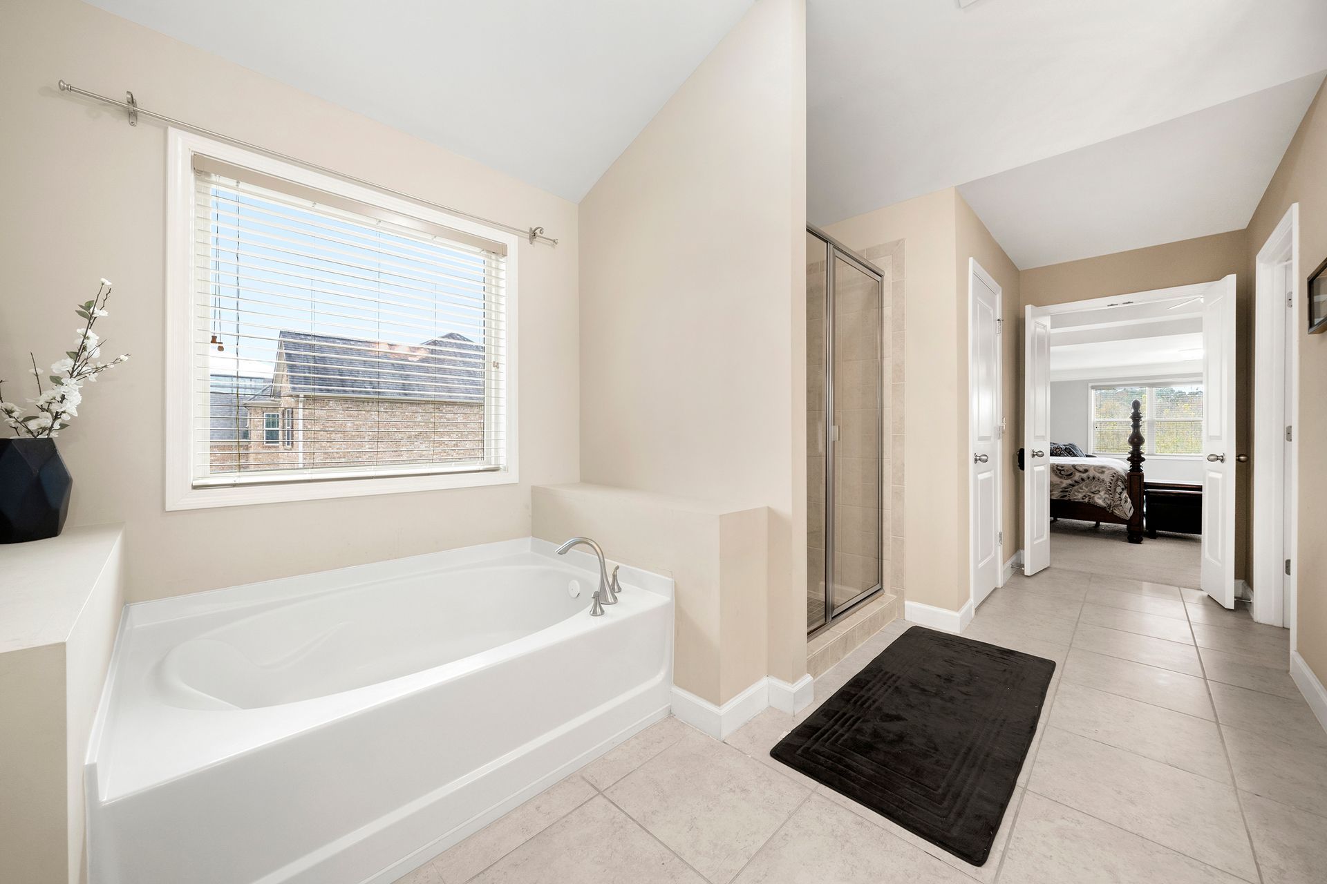 A bathroom with a bathtub and a window