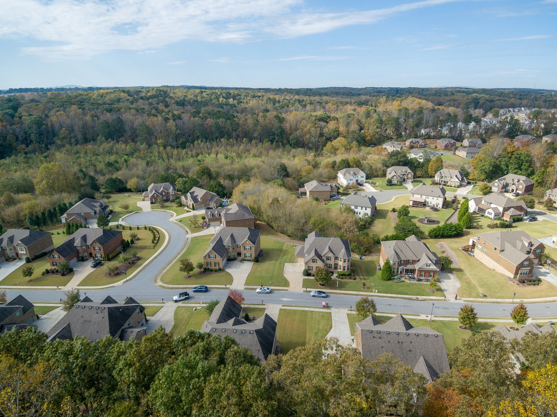 An aerial view of a residential area with lots of houses and trees.