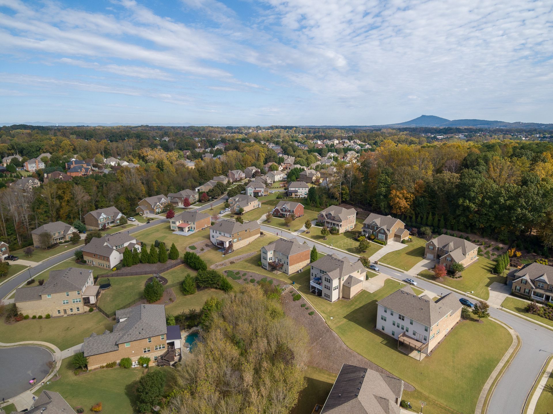 An aerial view of a residential neighborhood with lots of houses and trees.