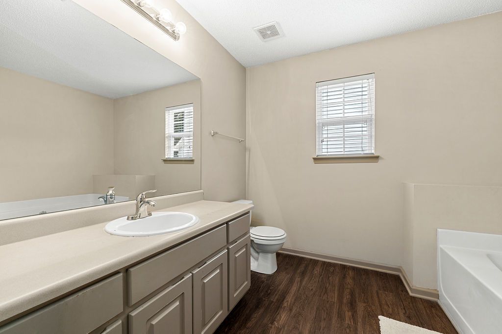 A bathroom with a sink , toilet , and bathtub.