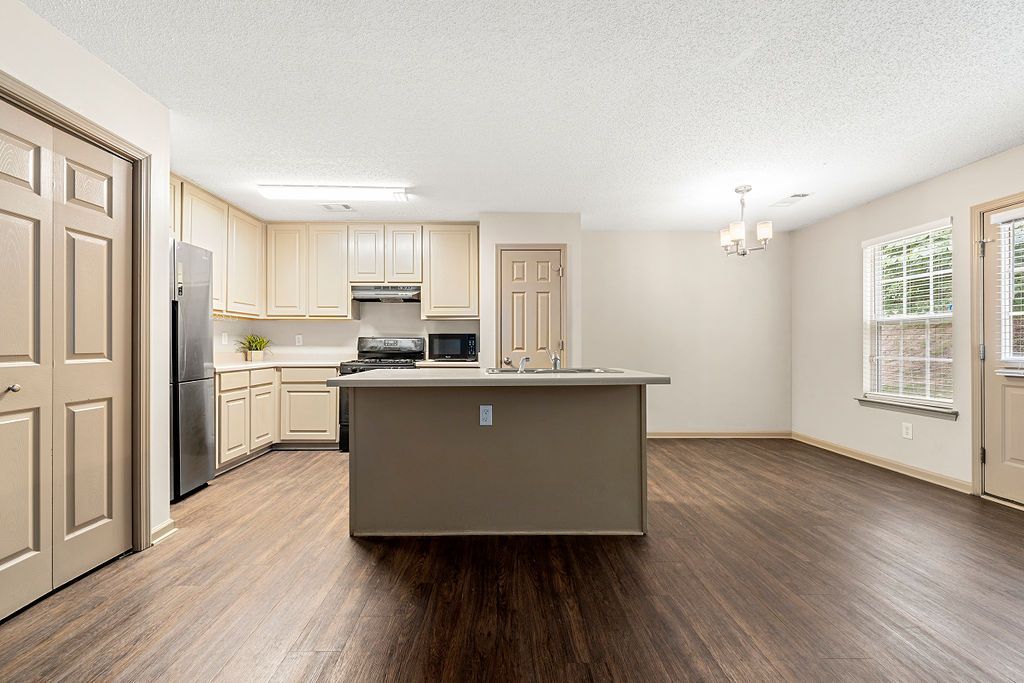 A kitchen with a large island in the middle of the room.