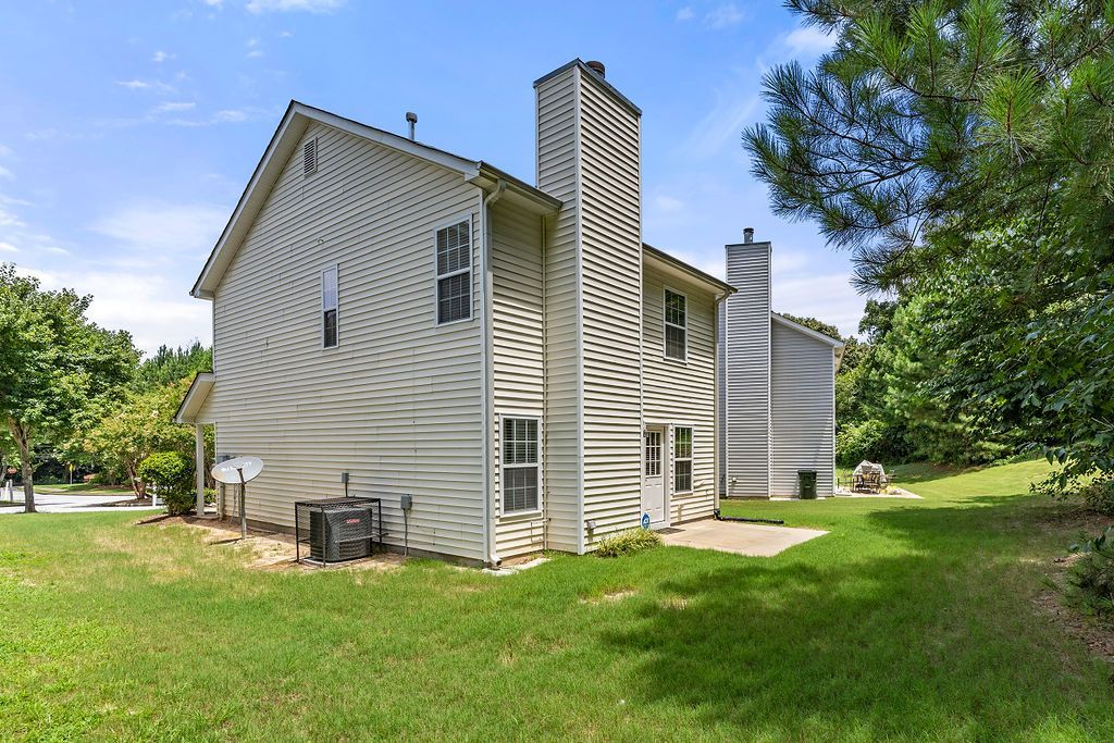 A large white house with a chimney in the backyard