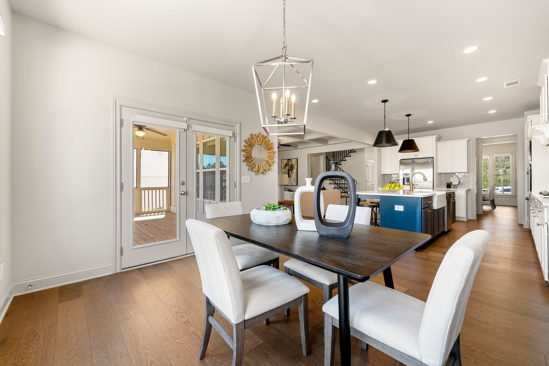 A dining room with a table and chairs and a chandelier.