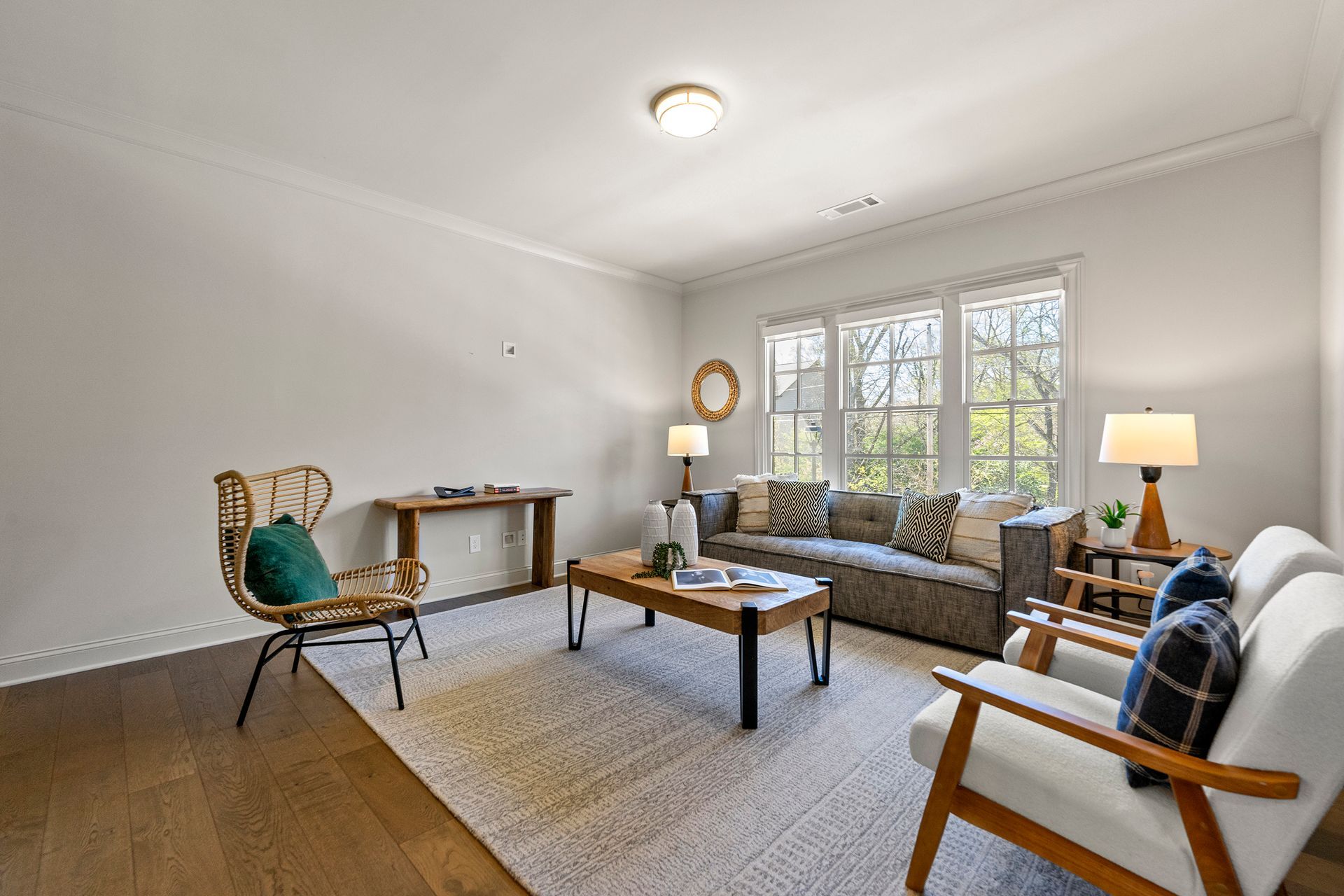 A living room with a couch , chairs , and a coffee table.
