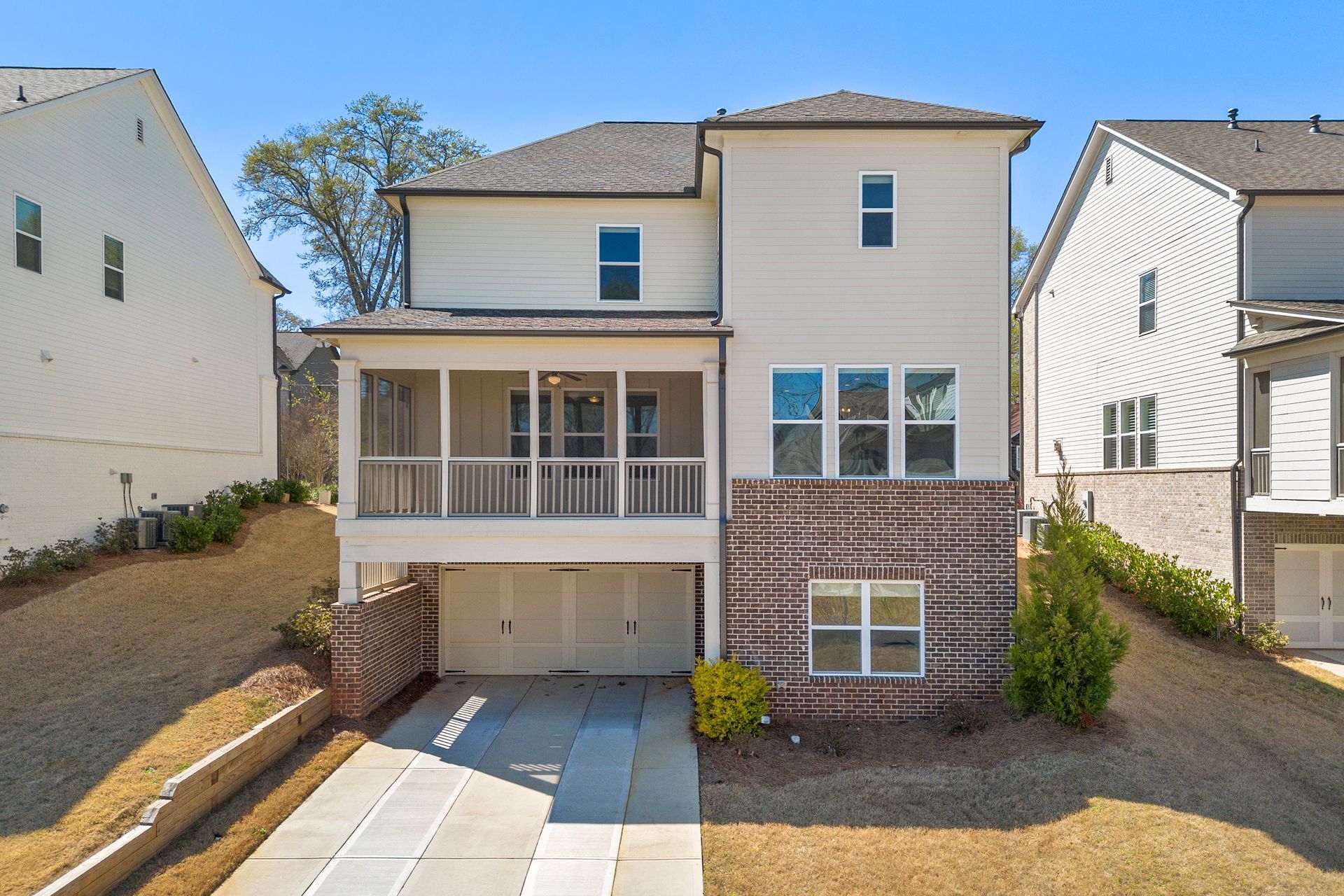 An aerial view of a house with a large garage and a porch.