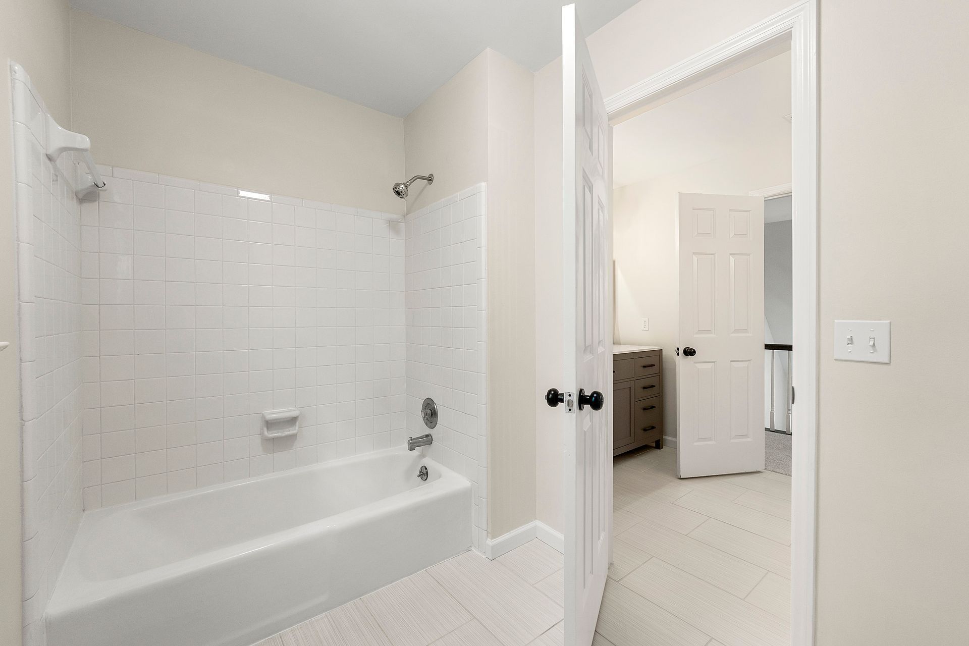 A bathroom with a bathtub and a shower.