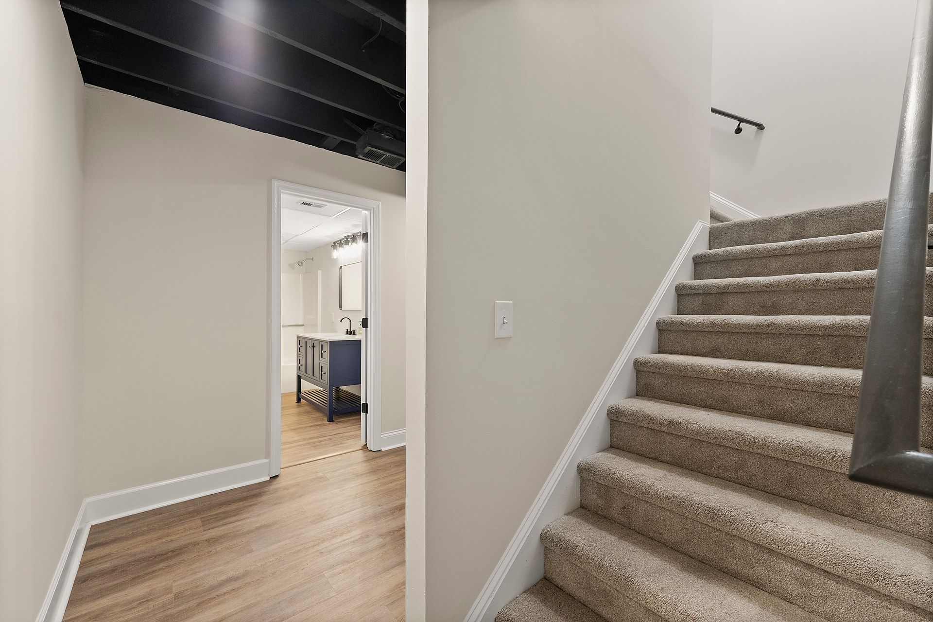 A hallway with stairs leading up to the second floor of a house.