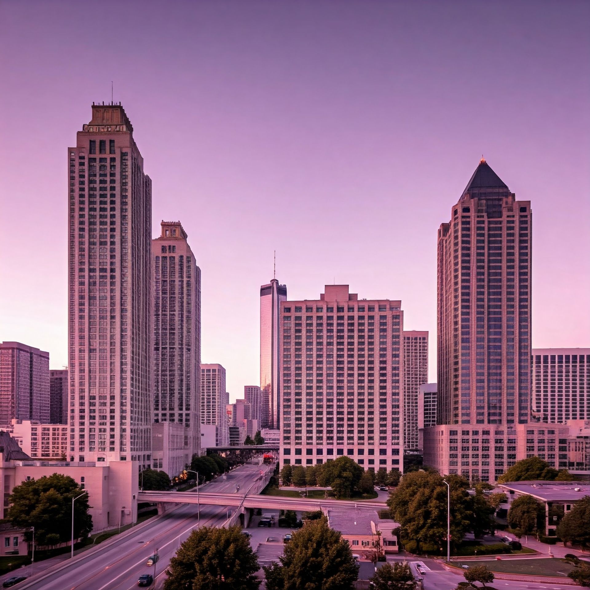 A cityscape with a purple sky and lots of tall buildings