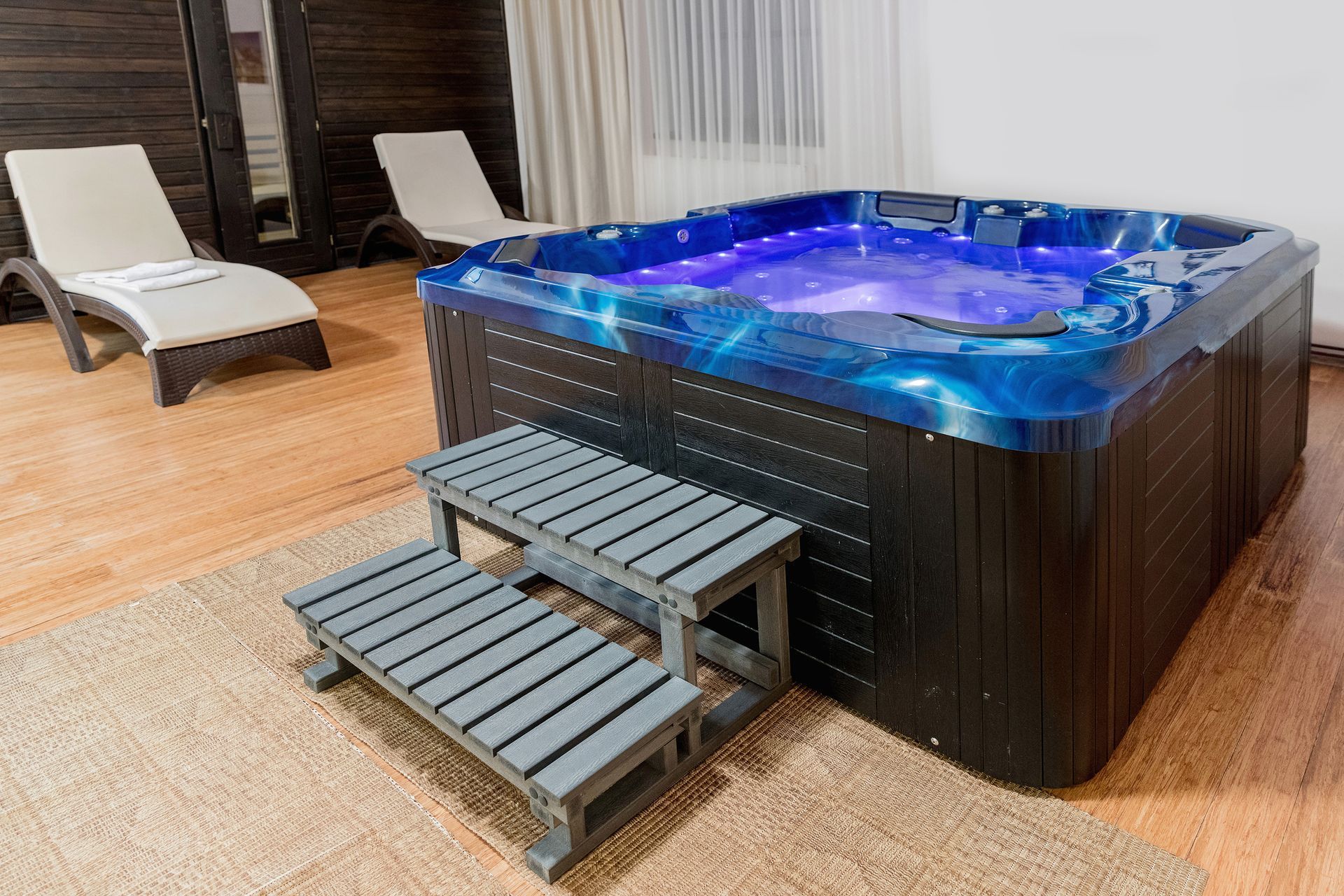 Indoor hot tub suite for relaxation with a blue whirlpool hot tub in Maple Shade, NJ by Half Price Hot Tub for ultimate comfort.