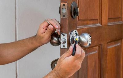 Locks — Man Fixing a Door Lock in South Bend, IN