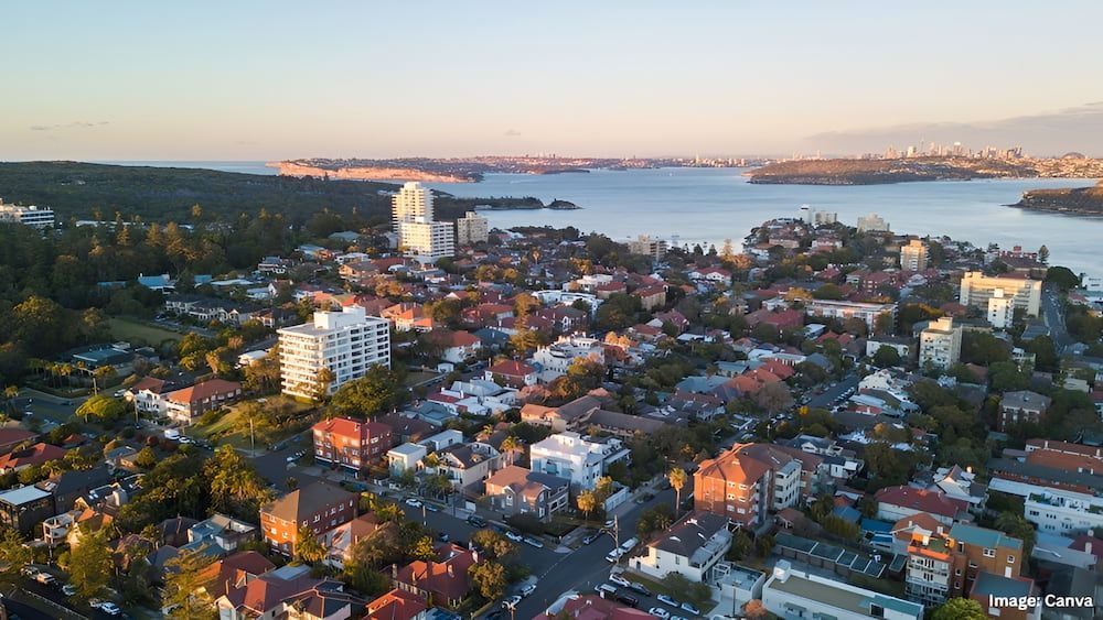 Aerial View of a City With Buildings and Trees Near a Body of Water — Into Finance Lending Solutions in Coomba Bay, NSW