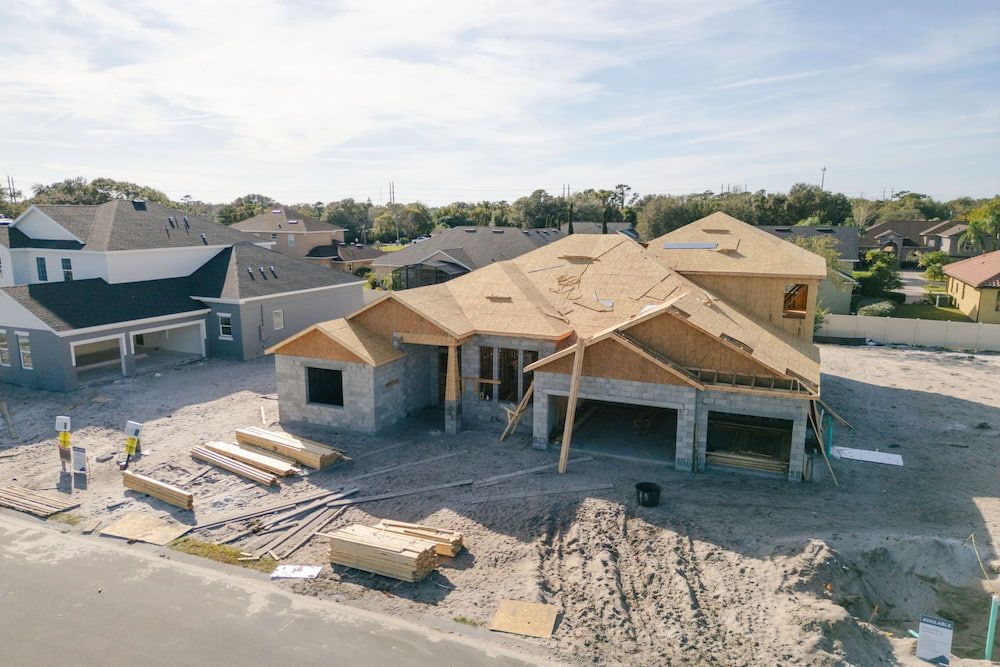 House Under Construction With Exposed Roof and Framing, in a Residential Neighborhood — Into Finance Lending Solutions in Coomba Bay, NSW