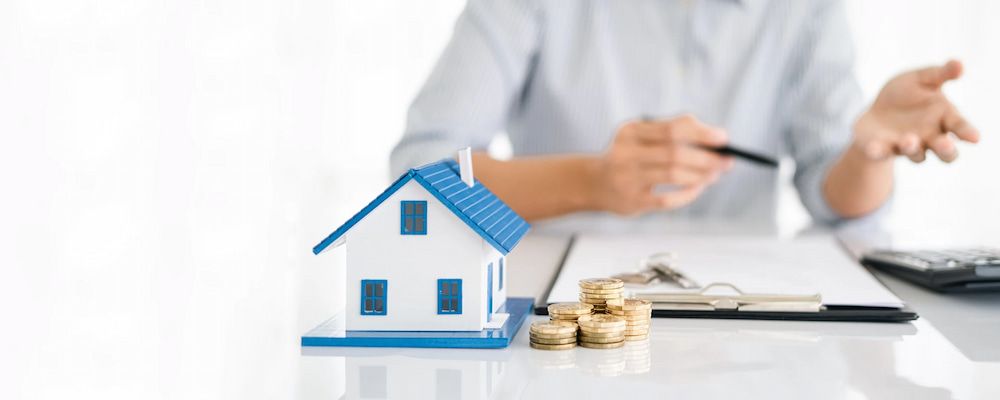A Miniature House, Coins, and Keys Sit on a Desk — Into Finance Lending Solutions in Nabiac, NSW