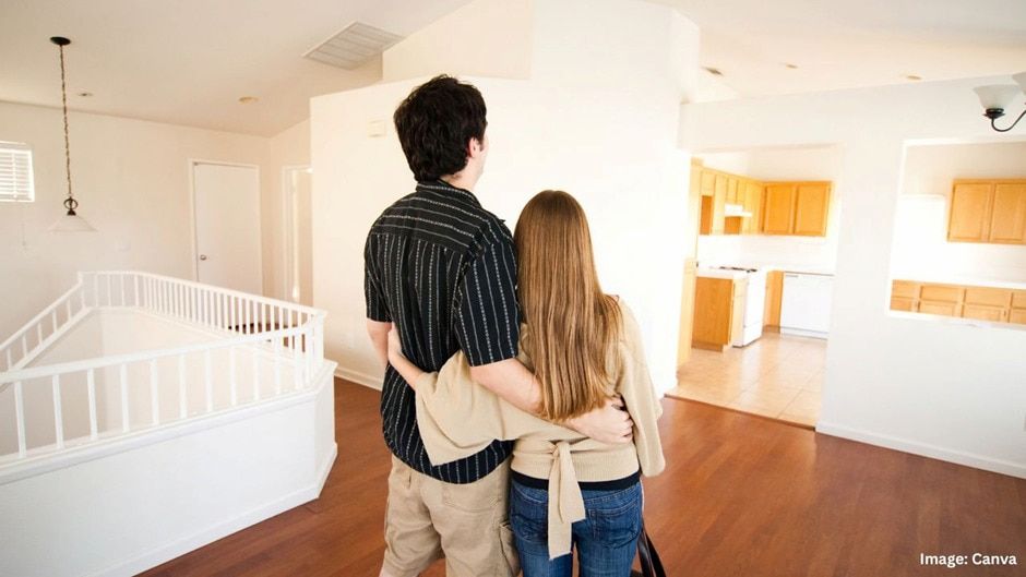Couple Looking at a Spacious, Empty Home Interior With Hardwood Floors and a Bright Kitchen — Into Finance Lending Solutions in Diamond Beach, NSW