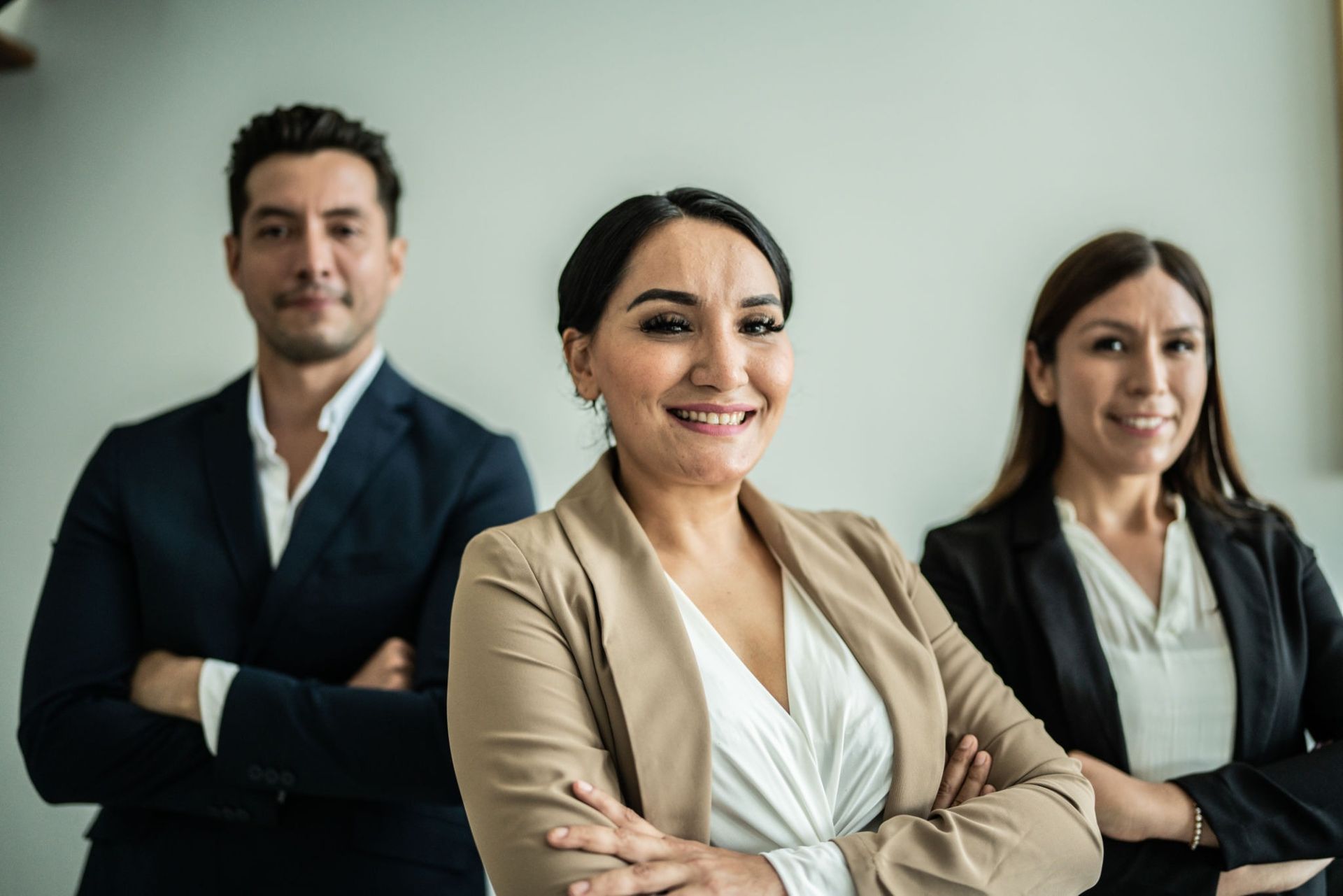 Three Professionals in Business Attire Smiling With Arms Crossed — Into Finance Lending Solutions in Coomba Bay, NSW