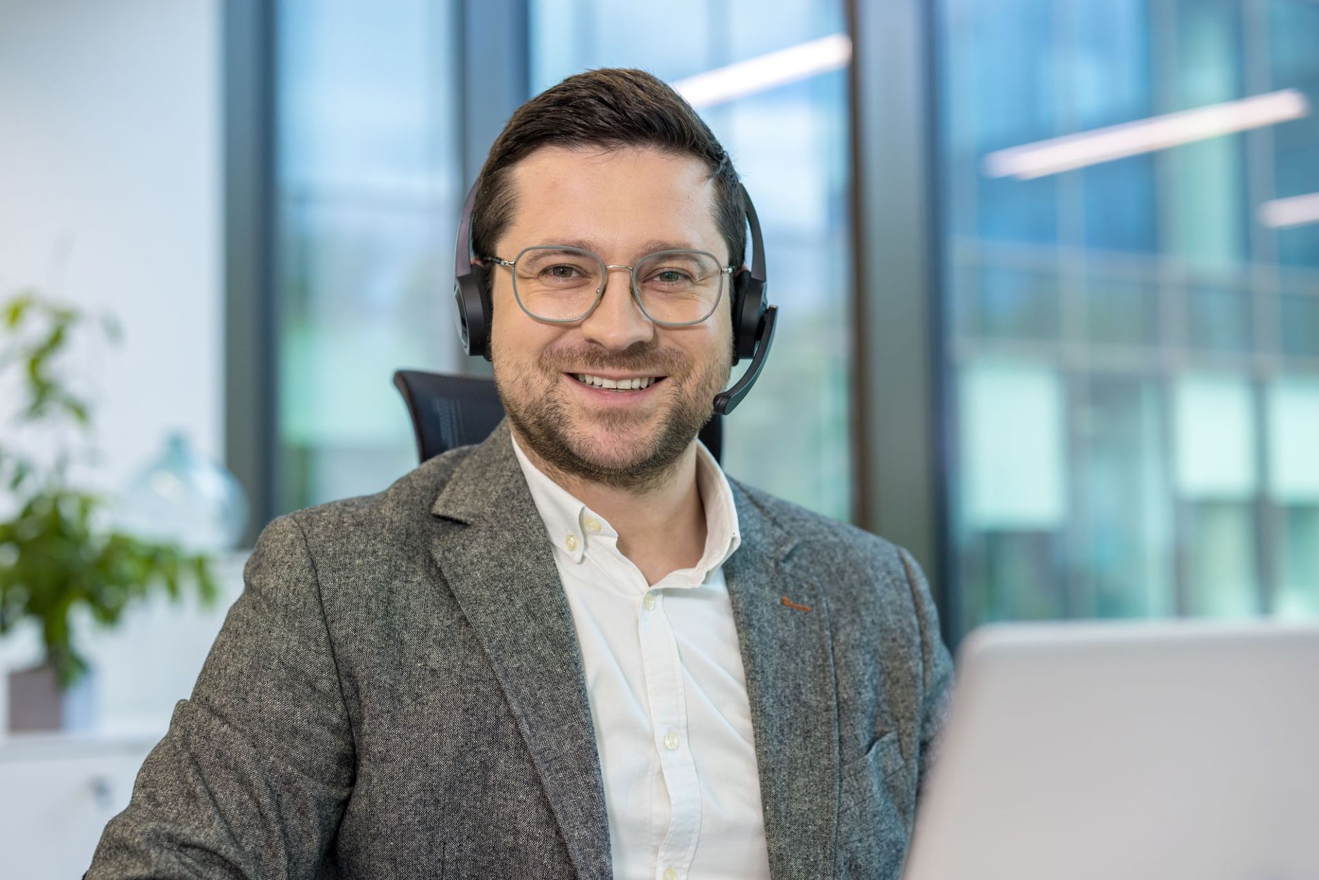 Man With Headset Smiles at the Camera — Into Finance Lending Solutions in Coomba Bay, NSW
