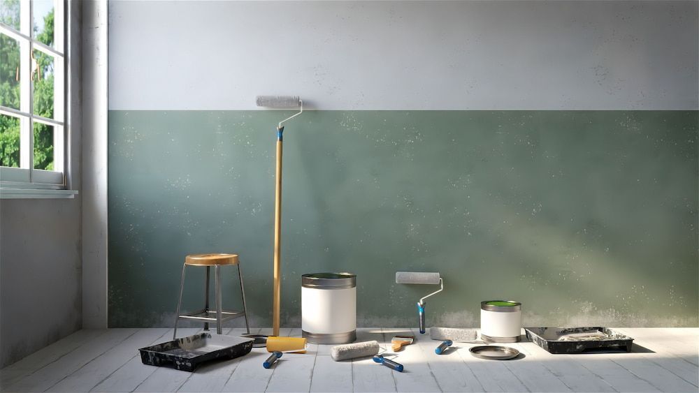 Paint Supplies Arranged in a Room With a Two-toned Wall — Into Finance Lending Solutions in Old Bar, NSW