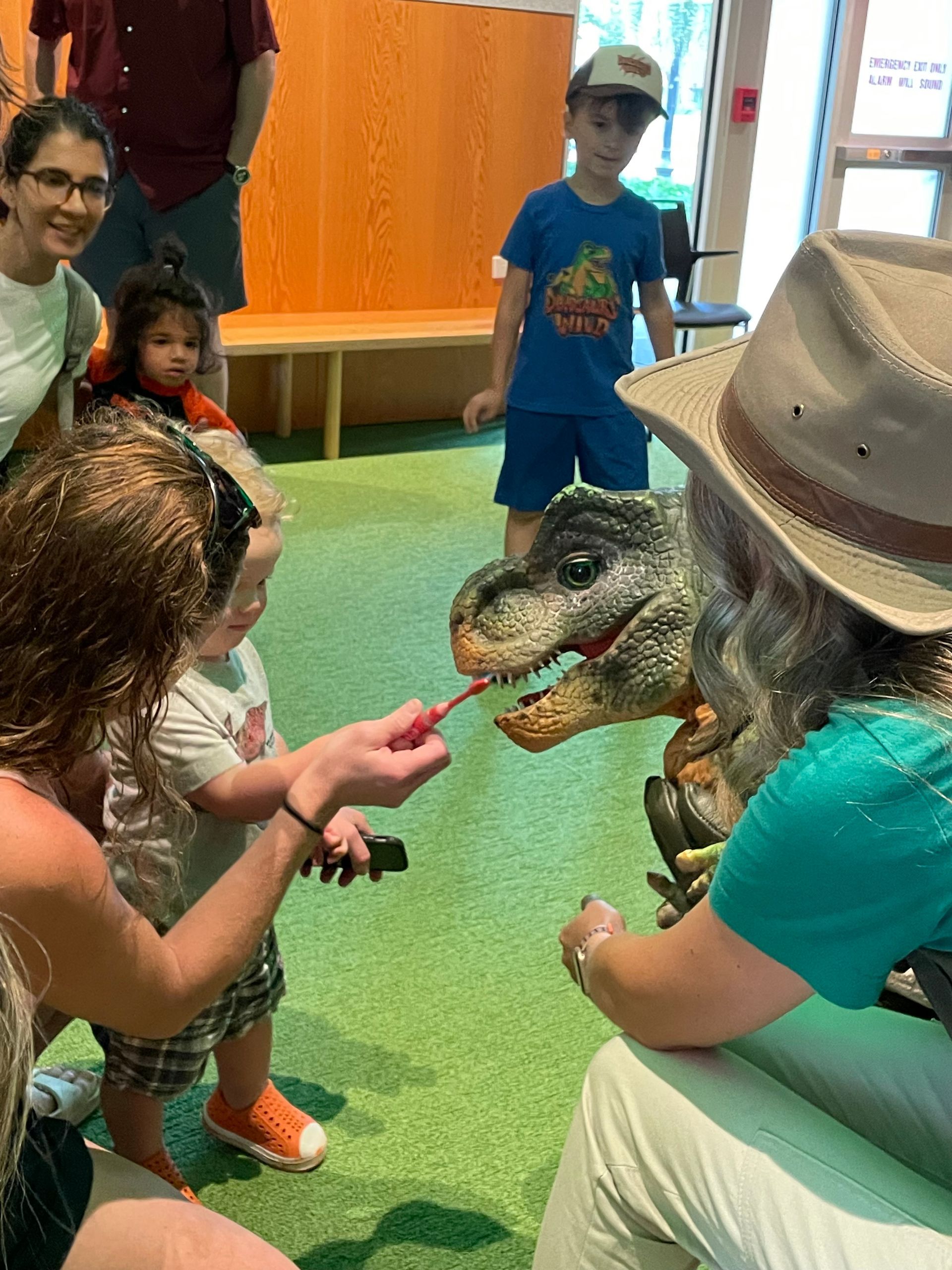 Child brushes T. rex's teeth
