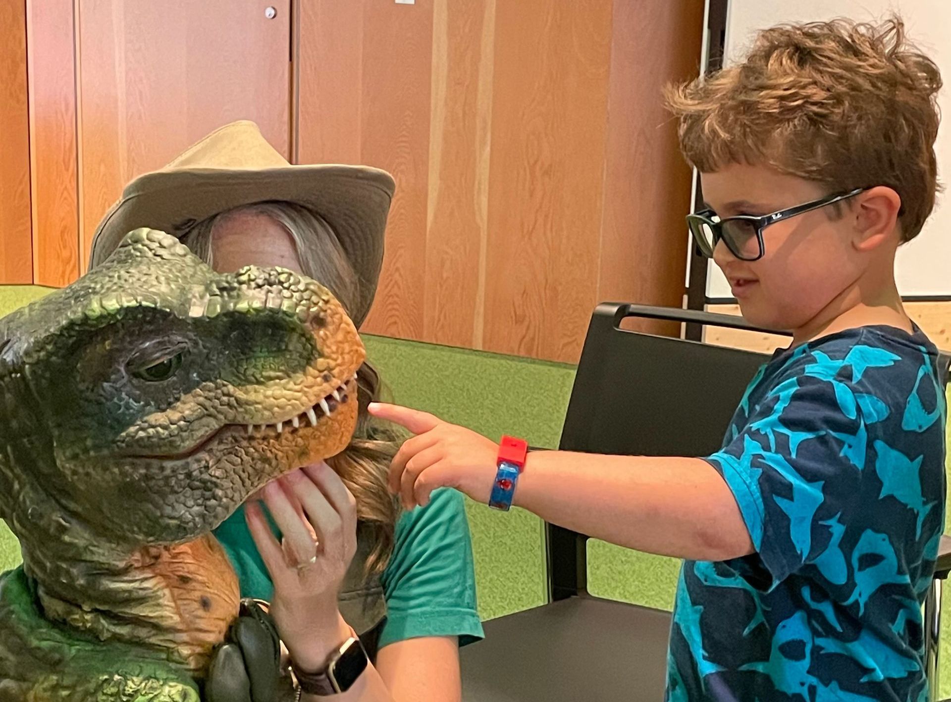 Dinosaur meets boy at the library