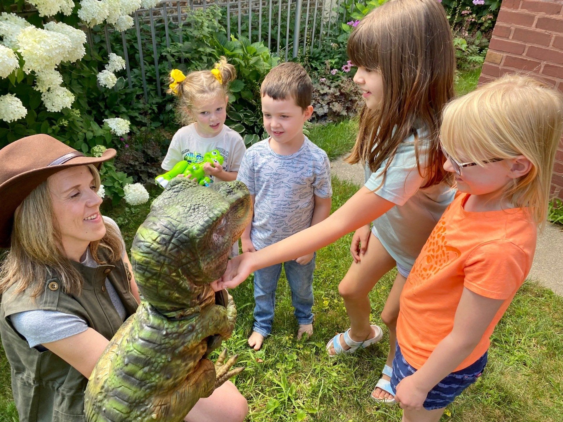 Dinosaur meets children at a party