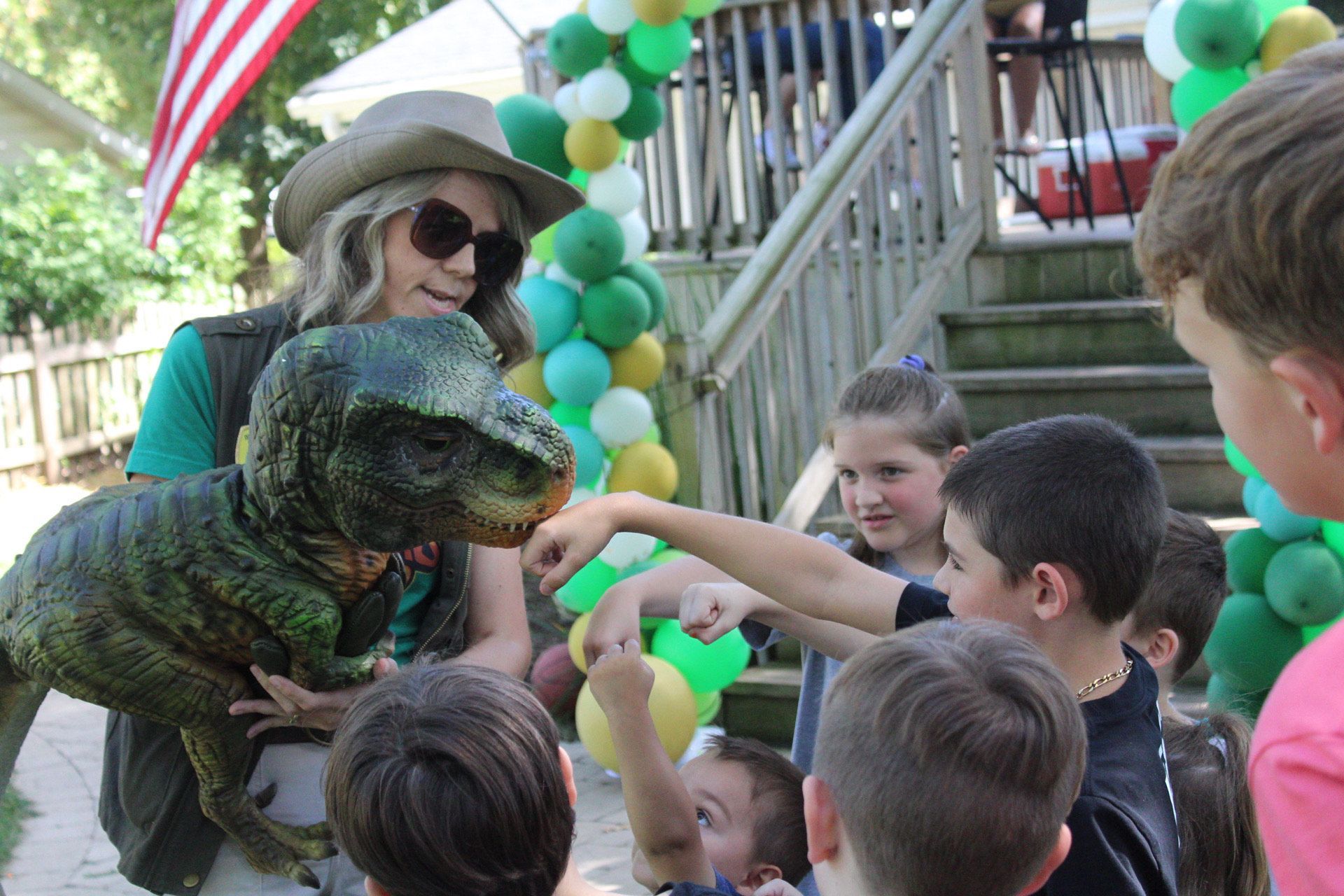 Dinosaur meets children at a birthday party