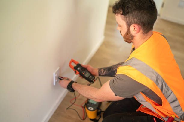 An electrician checks a power socket.
