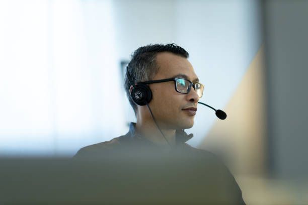 A man wearing glasses and a headset is talking on a phone. - Plymouth, MN - Legacy Pro