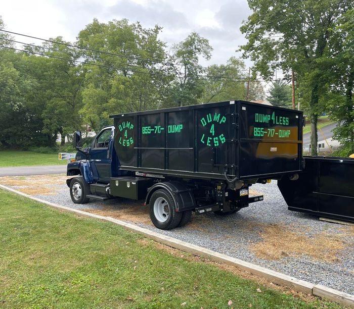 a dump 4 less truck is parked on the side of the road