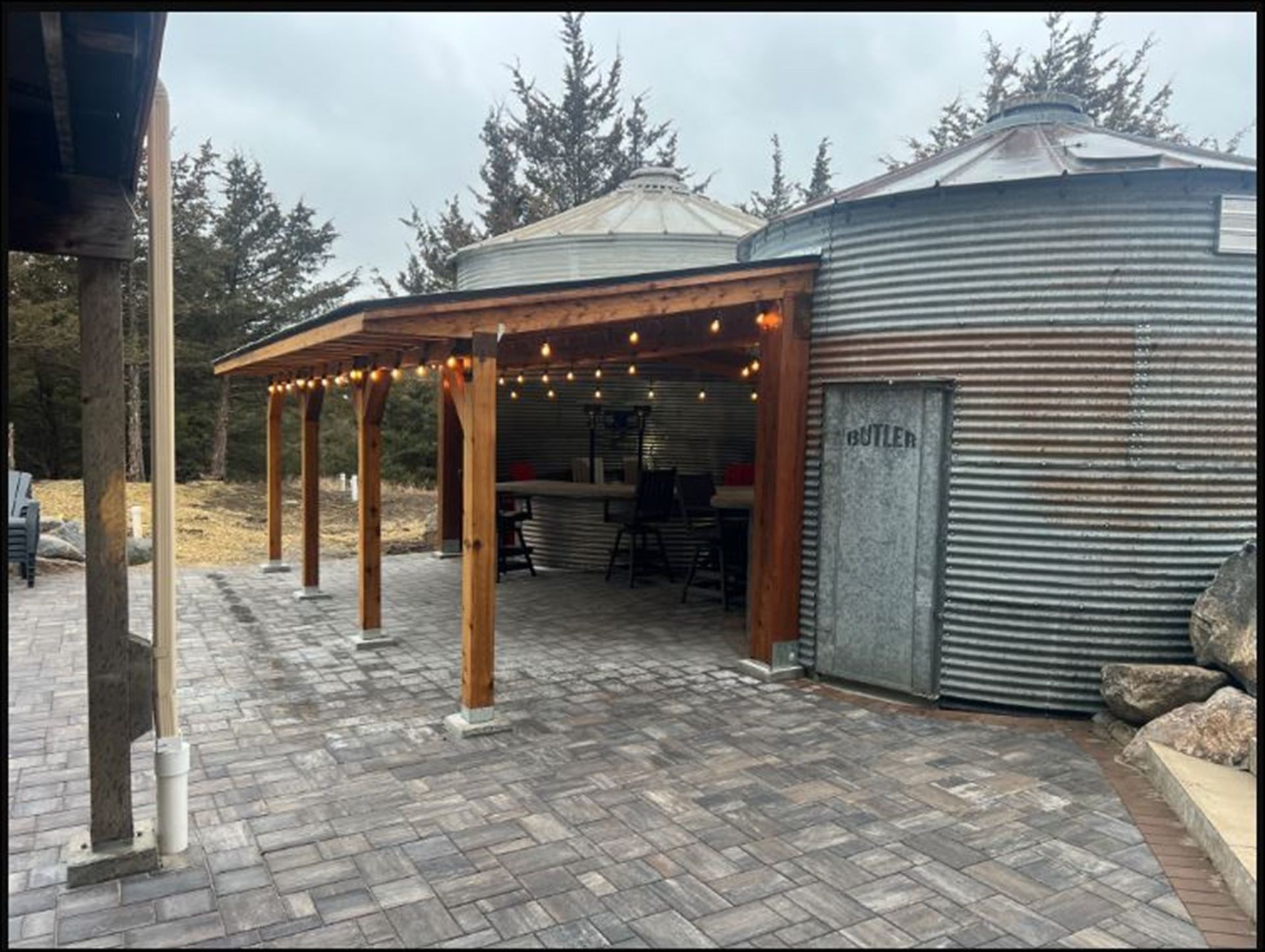 An outdoor patio with a bar and grill setup.