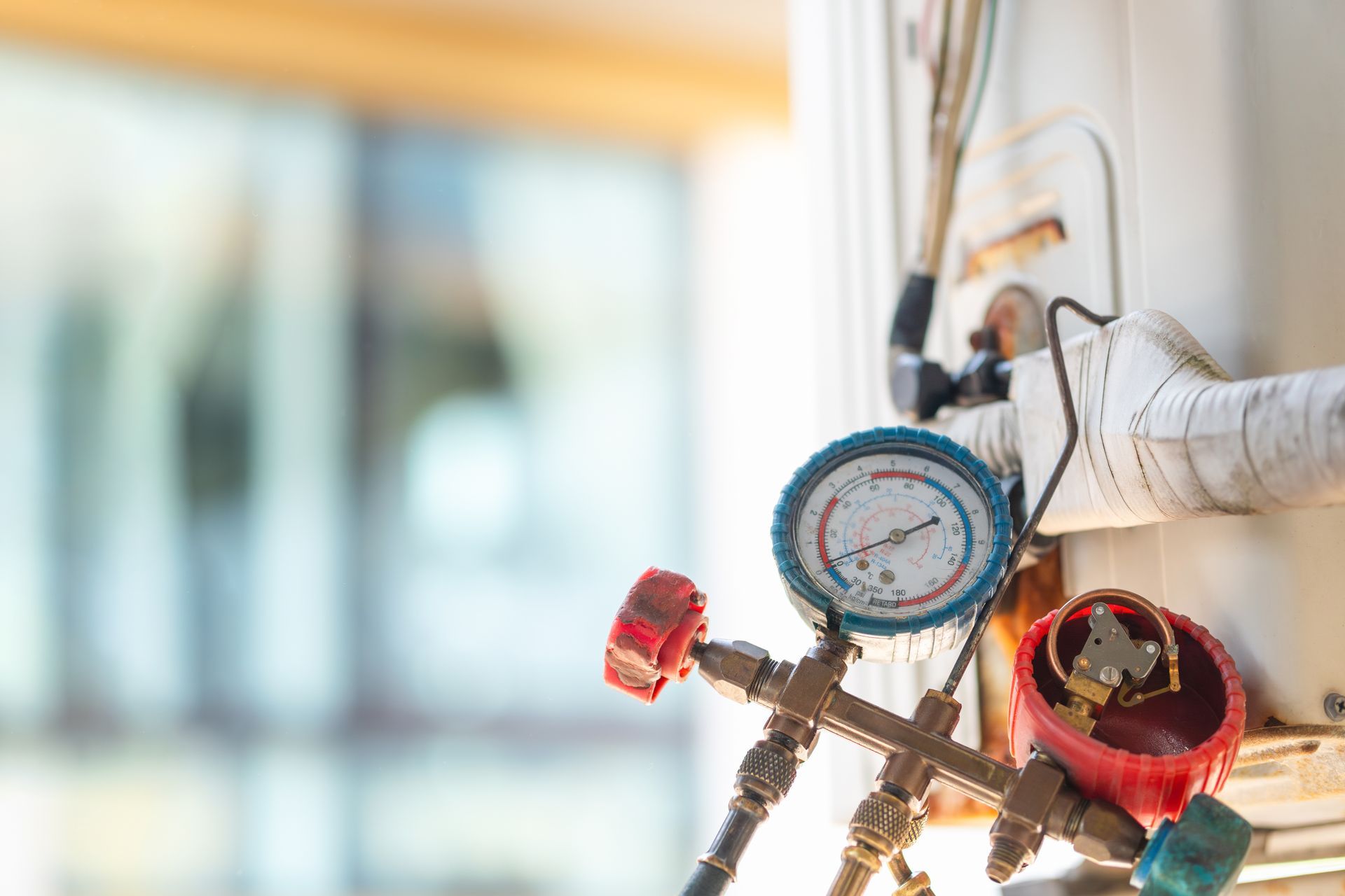 A close up of a couple of gauges on a wall.