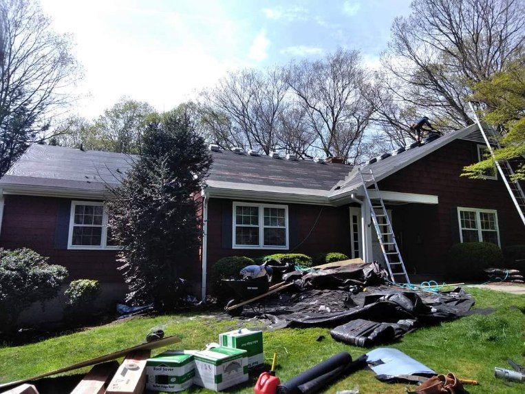 A roof is being installed on a brick house